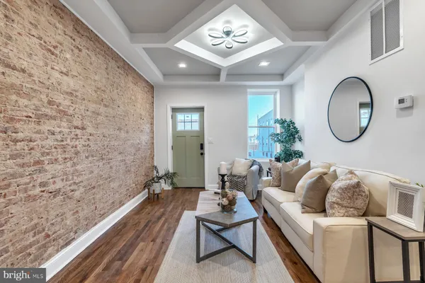 a living room with furniture and a mirror