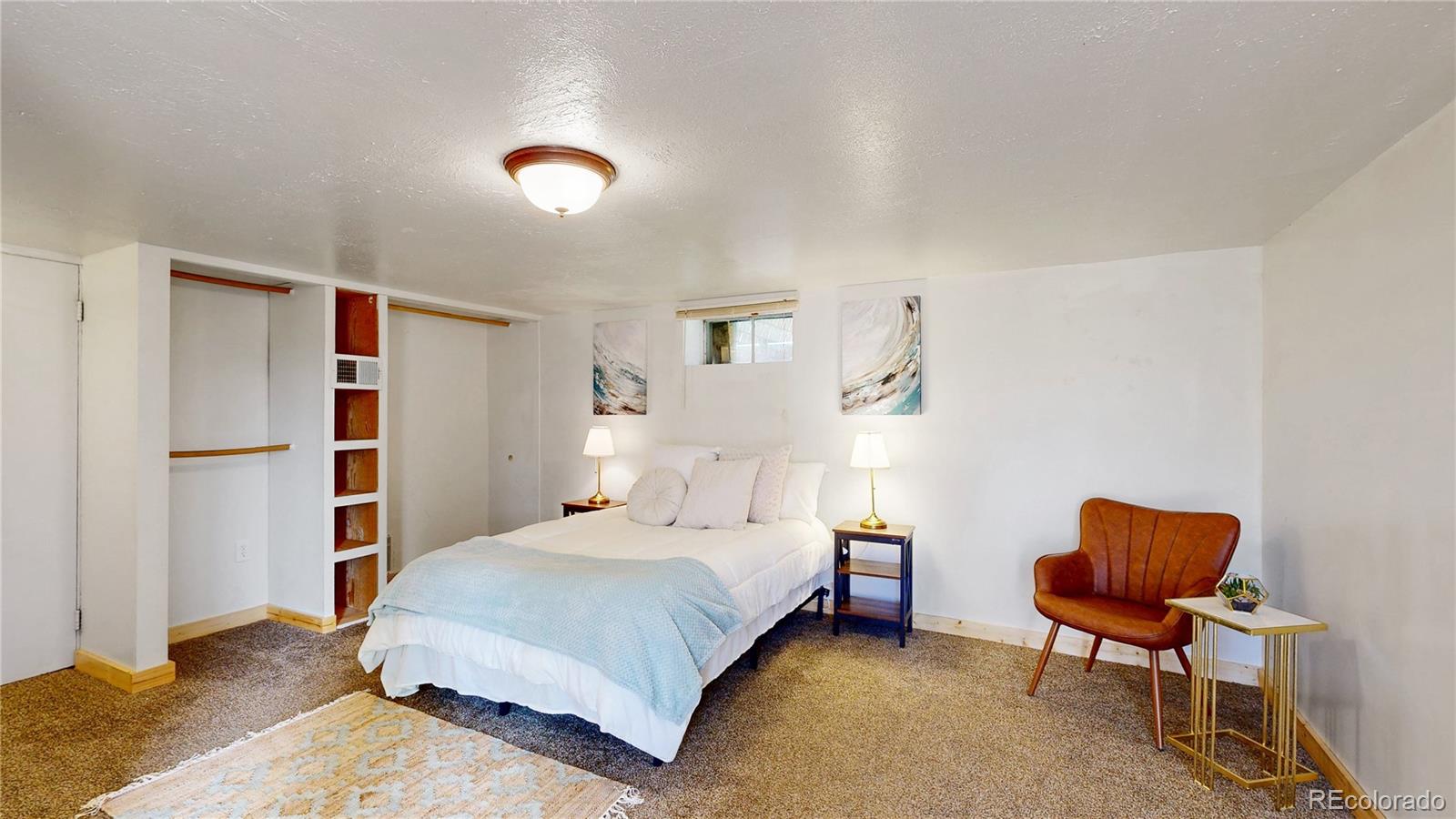 60 Ball Road Bailey, CO 80421 - Photo 11 of 37 a bedroom with a bed a chair and a book shelf