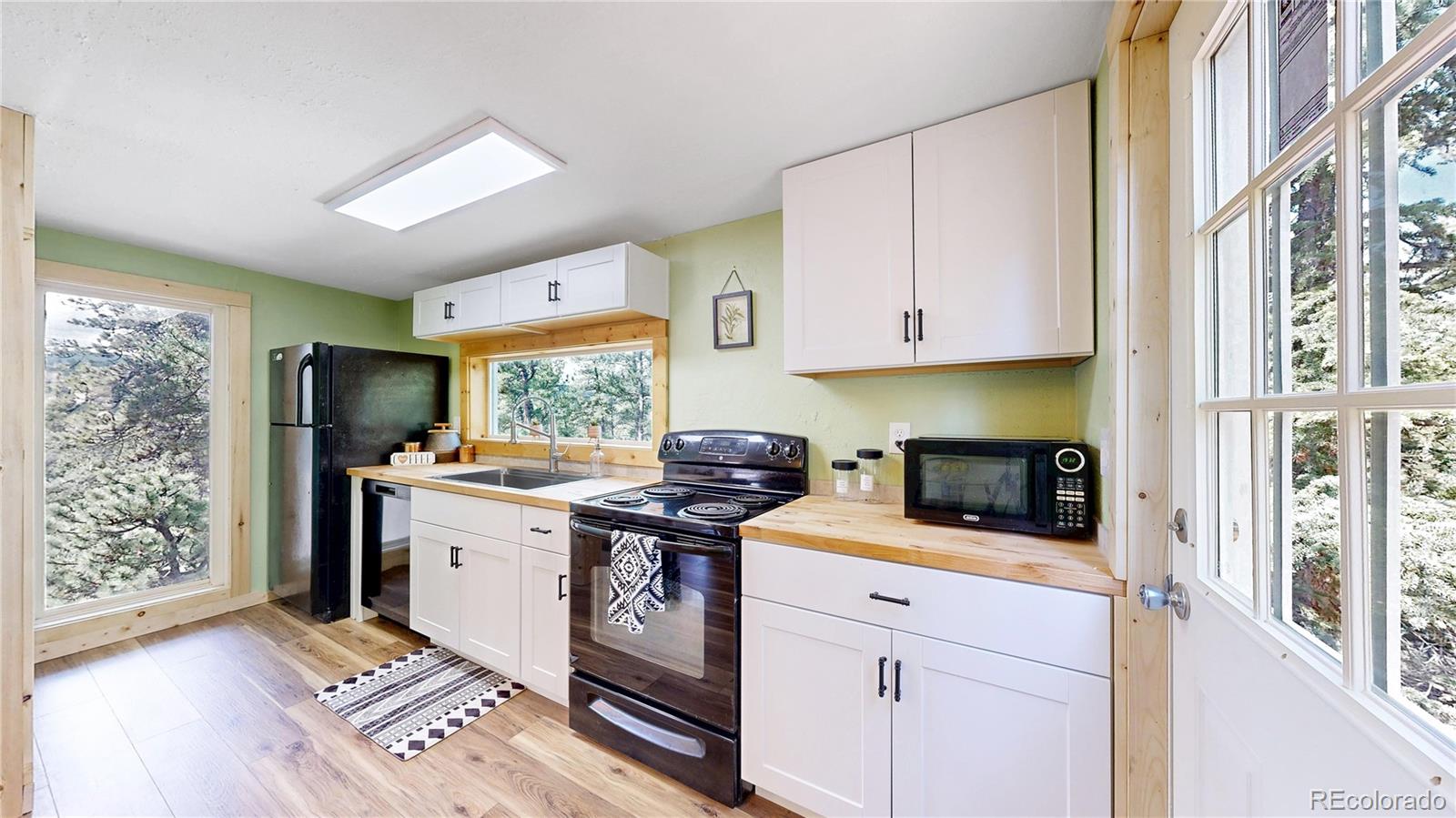 60 Ball Road Bailey, CO 80421 - Photo 5 of 37 a kitchen with stainless steel appliances granite countertop a stove a sink dishwasher and a refrigerator with wooden floor