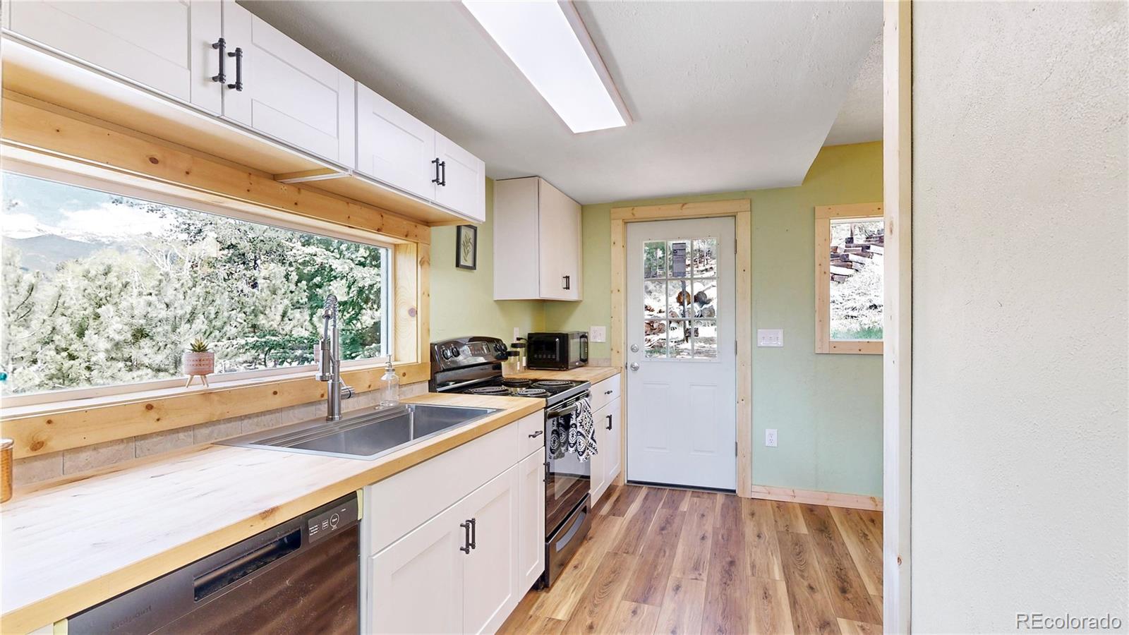 60 Ball Road Bailey, CO 80421 - Photo 6 of 37 a kitchen with a sink a stove and cabinets