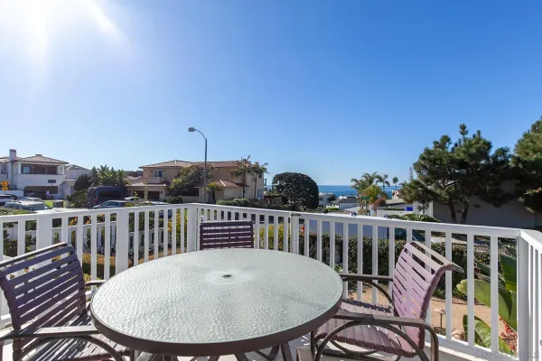 a view of a balcony with wooden floor and fence