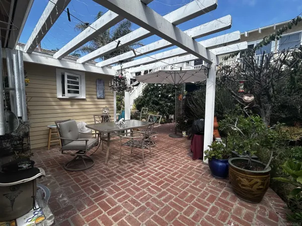 a view of a patio with chairs and plants