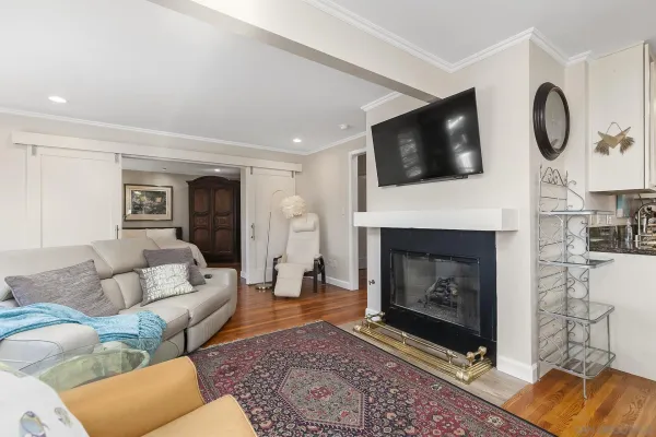 a living room with furniture a flat screen tv and a fireplace