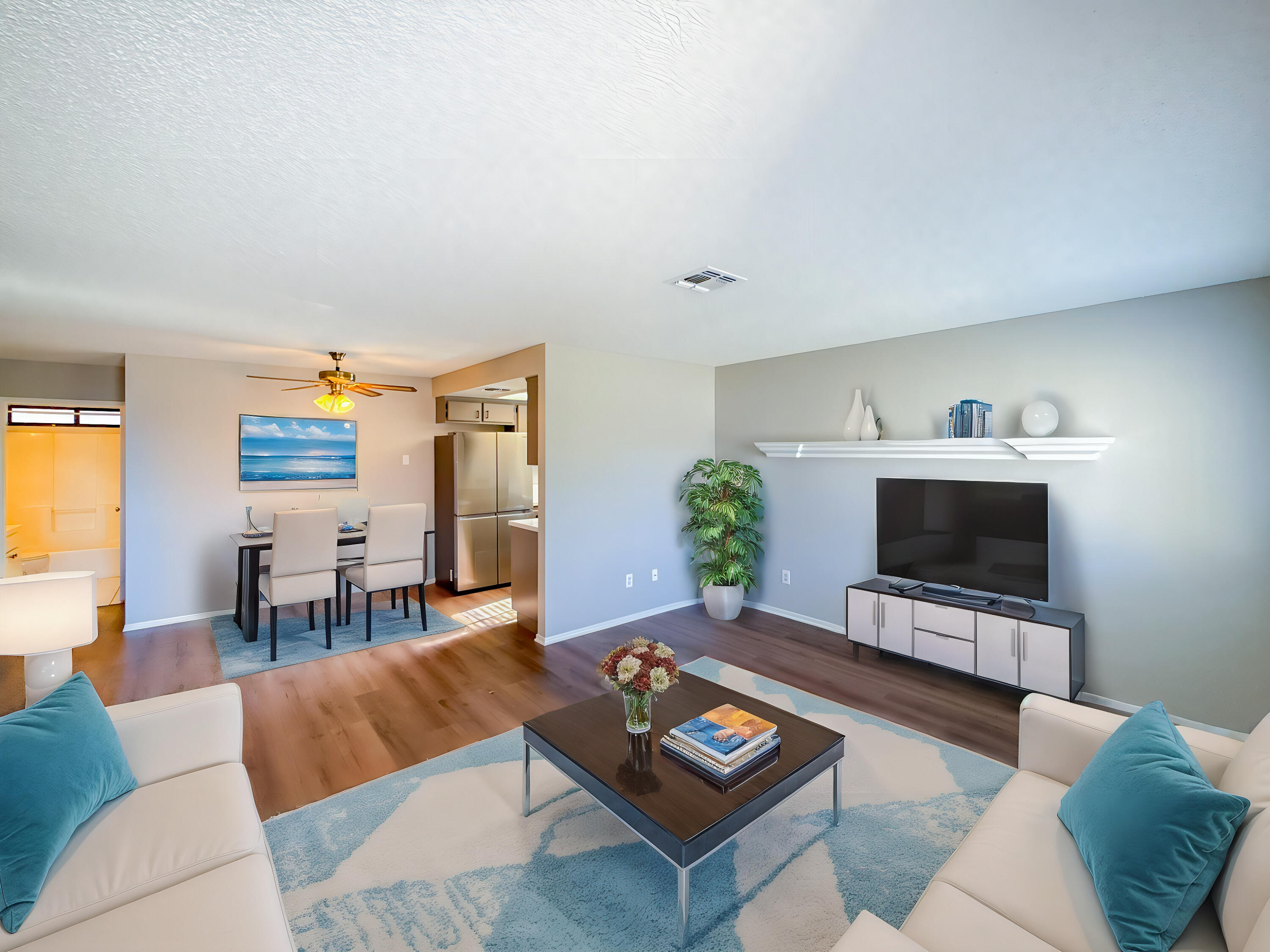 43840 Bobby Jones Drive, Unit 24 Lancaster, CA 93536 - Photo 11 of 29 a living room with furniture and a flat screen tv