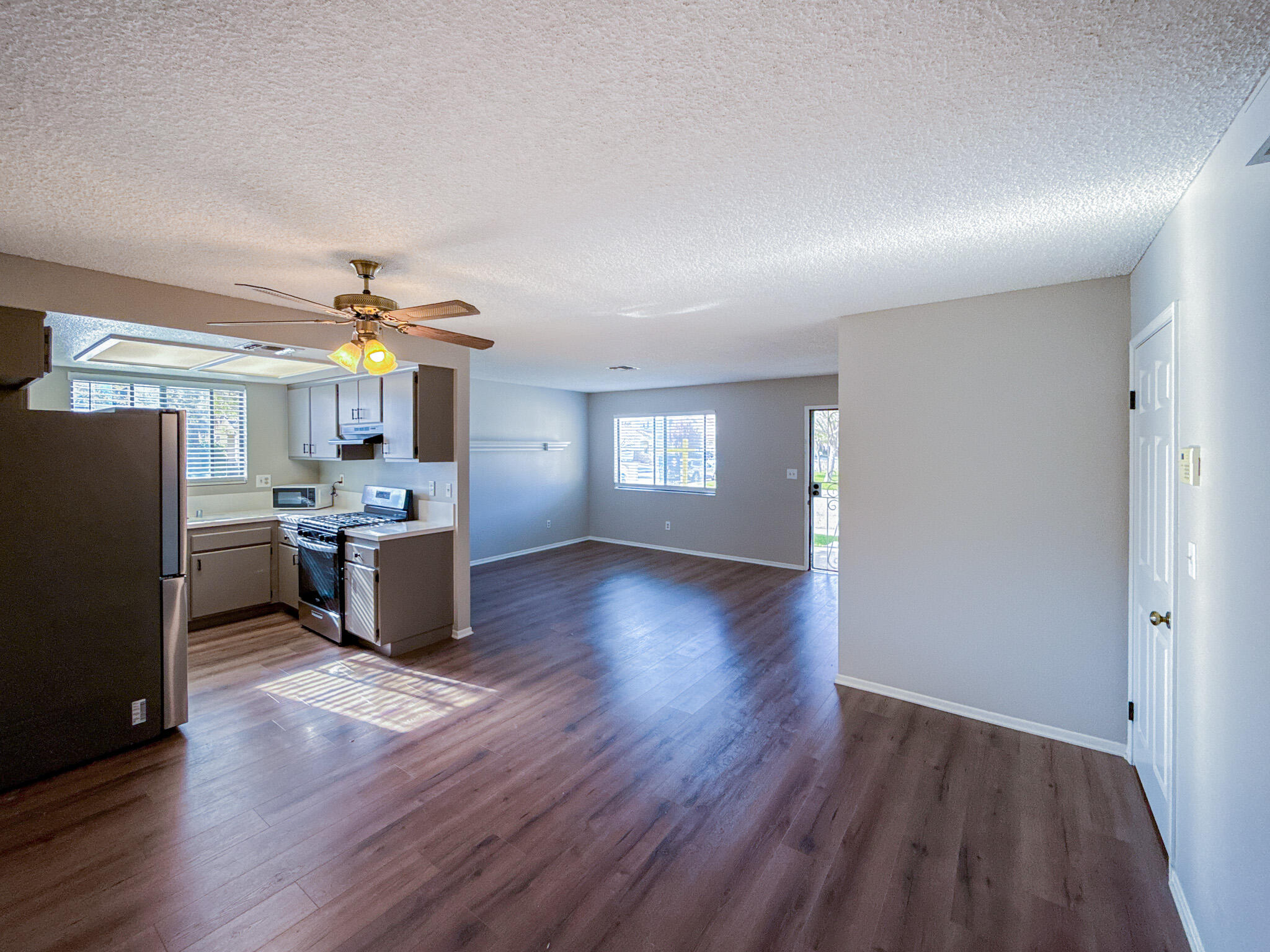 43840 Bobby Jones Drive, Unit 24 Lancaster, CA 93536 - Photo 12 of 29 a view of a kitchen and dining room with wooden floor
