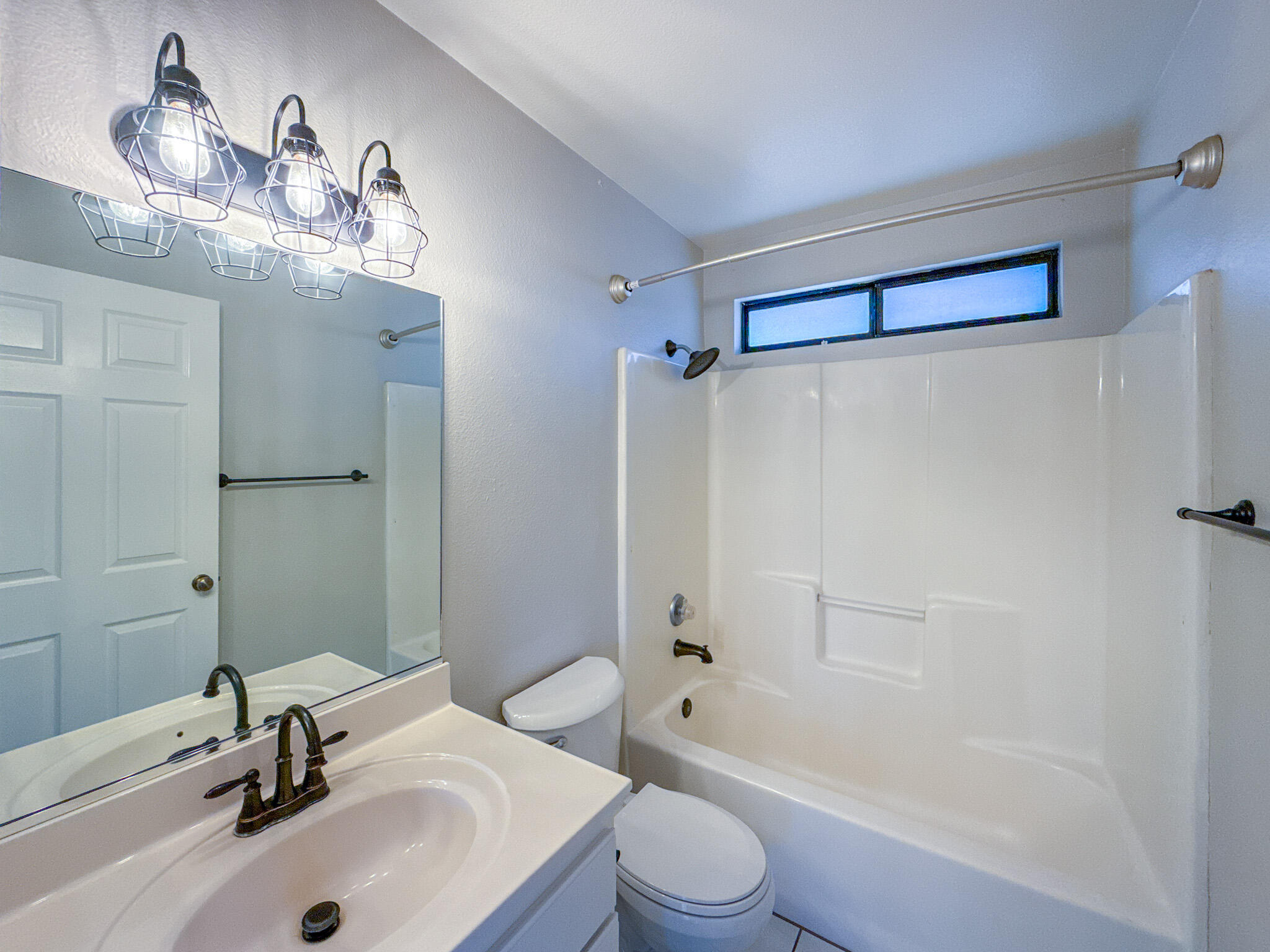 43840 Bobby Jones Drive, Unit 24 Lancaster, CA 93536 - Photo 23 of 29 a bathroom with a sink a toilet and shower