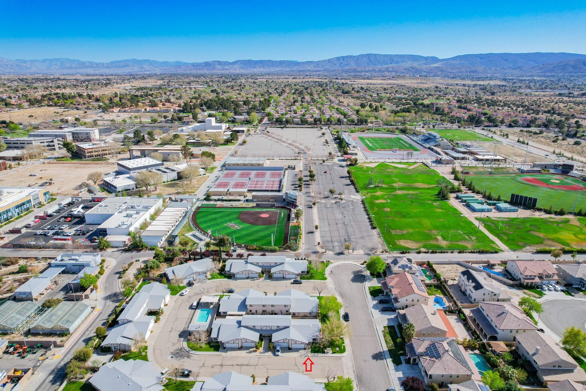 43840 Bobby Jones Drive, Unit 24 Lancaster, CA 93536 - Photo 29 of 29 an aerial view of a city with lots of residential buildings ocean and mountain view in back
