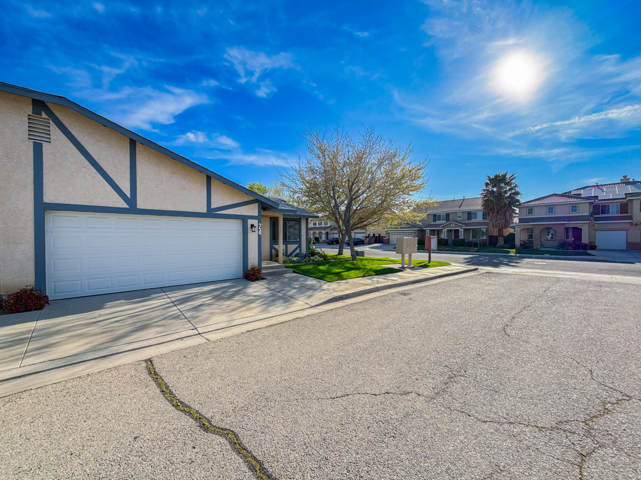 43840 Bobby Jones Drive, Unit 24 Lancaster, CA 93536 - Photo 3 of 29 a view of road and house on its side with small garden and wooden fence