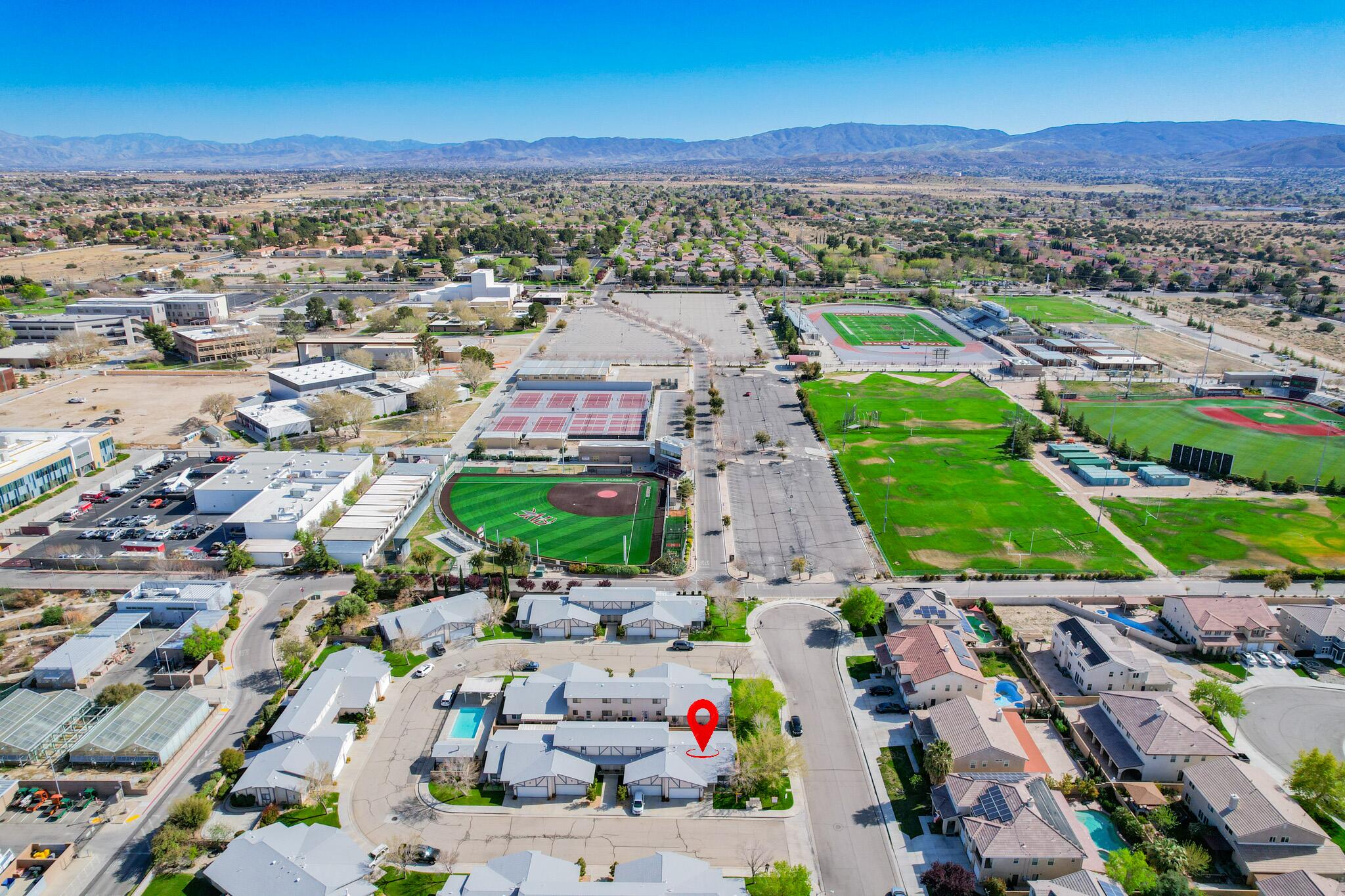 43840 Bobby Jones Drive, Unit 24 Lancaster, CA 93536 - Photo 6 of 29 an aerial view of a city with lots of residential buildings ocean and mountain view in back