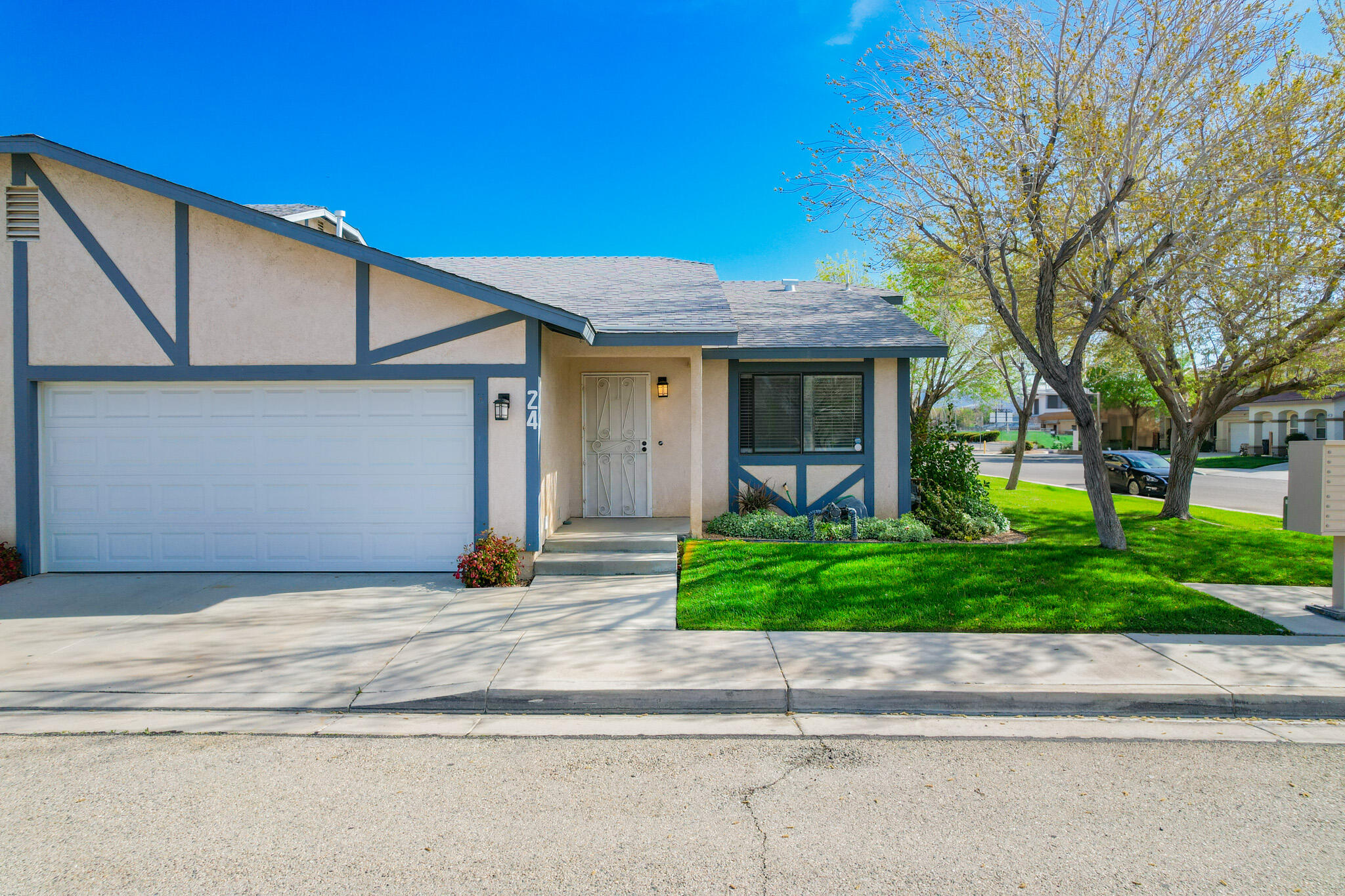 43840 Bobby Jones Drive, Unit 24 Lancaster, CA 93536 - Photo 8 of 29 a view of a house with a garden
