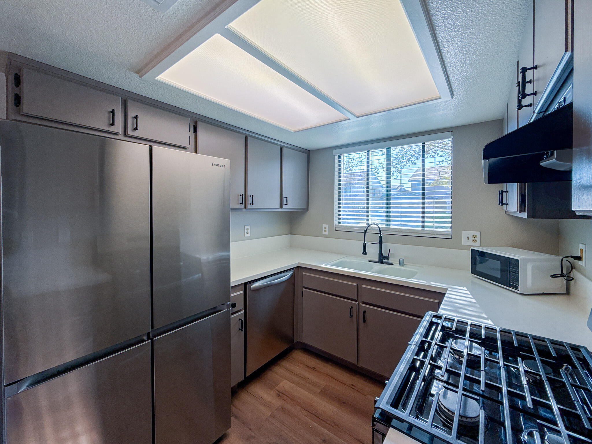 43840 Bobby Jones Drive, Unit 24 Lancaster, CA 93536 - Photo 10 of 29 a kitchen with stainless steel appliances granite countertop a refrigerator and a sink