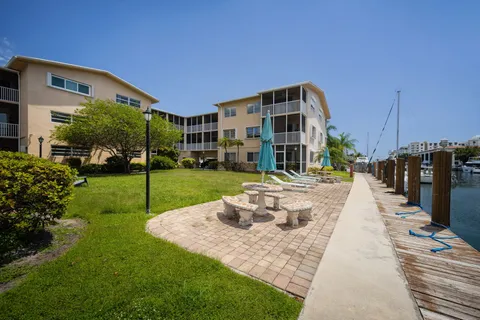 a front view of a building with a garden