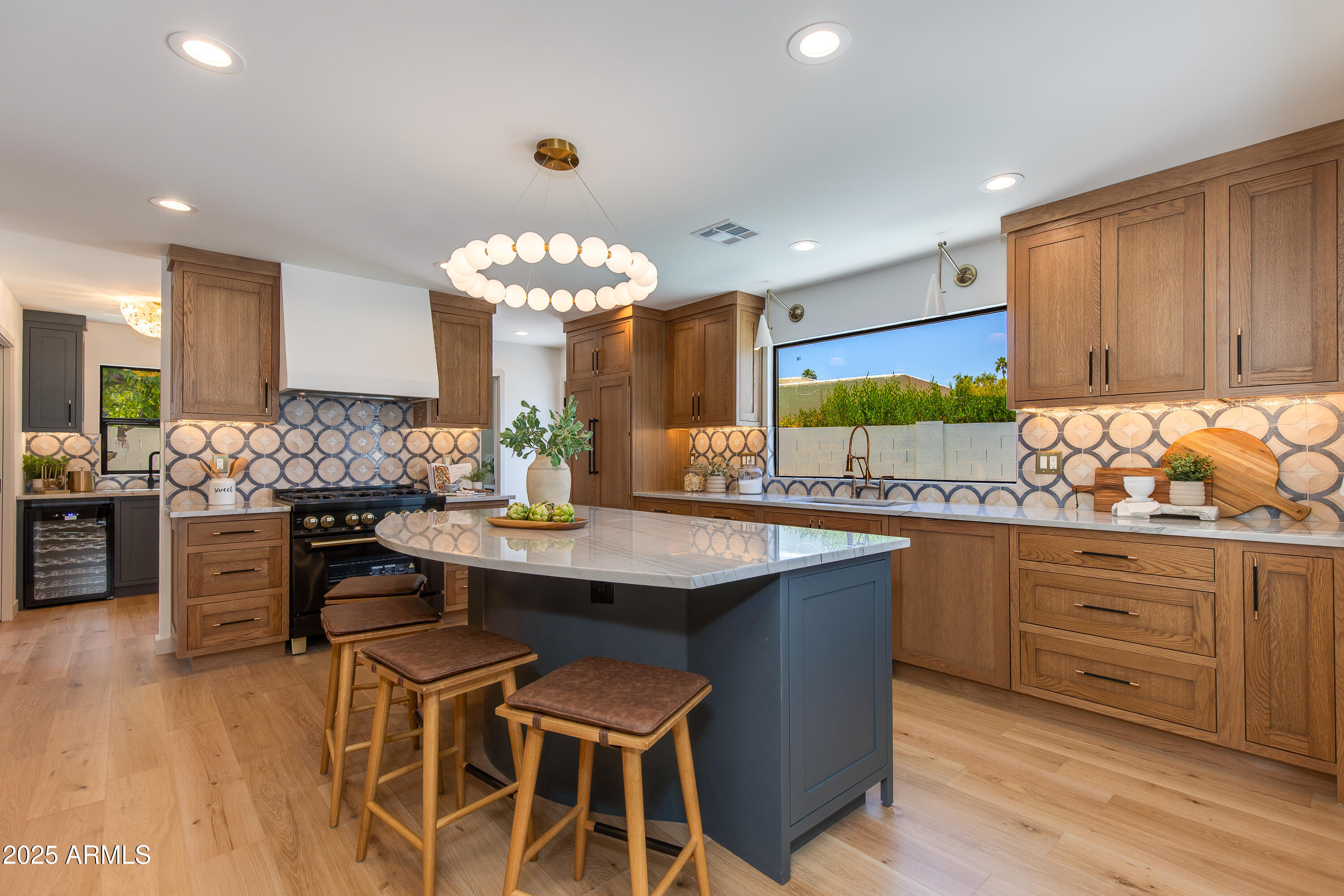 7328 East Laredo Lane Scottsdale, AZ 85250 - Photo 1 of 27 a kitchen with stainless steel appliances kitchen island granite countertop a table and chairs in it