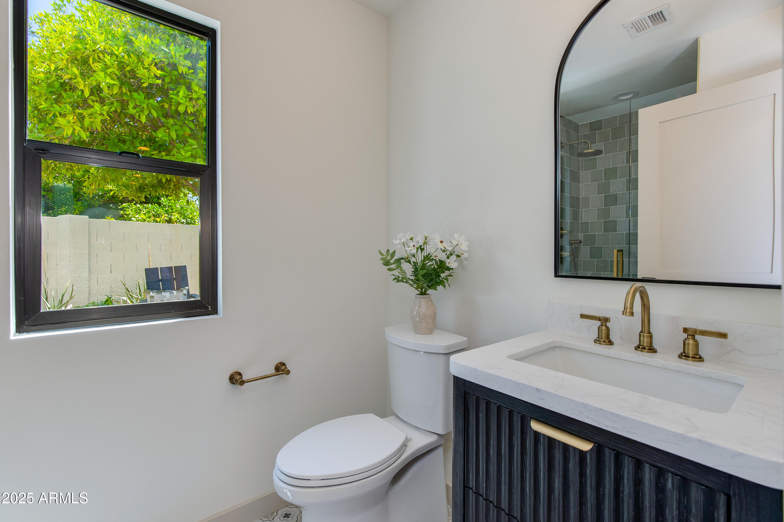 7328 East Laredo Lane Scottsdale, AZ 85250 - Photo 11 of 27 a bathroom with a sink a toilet and a mirror