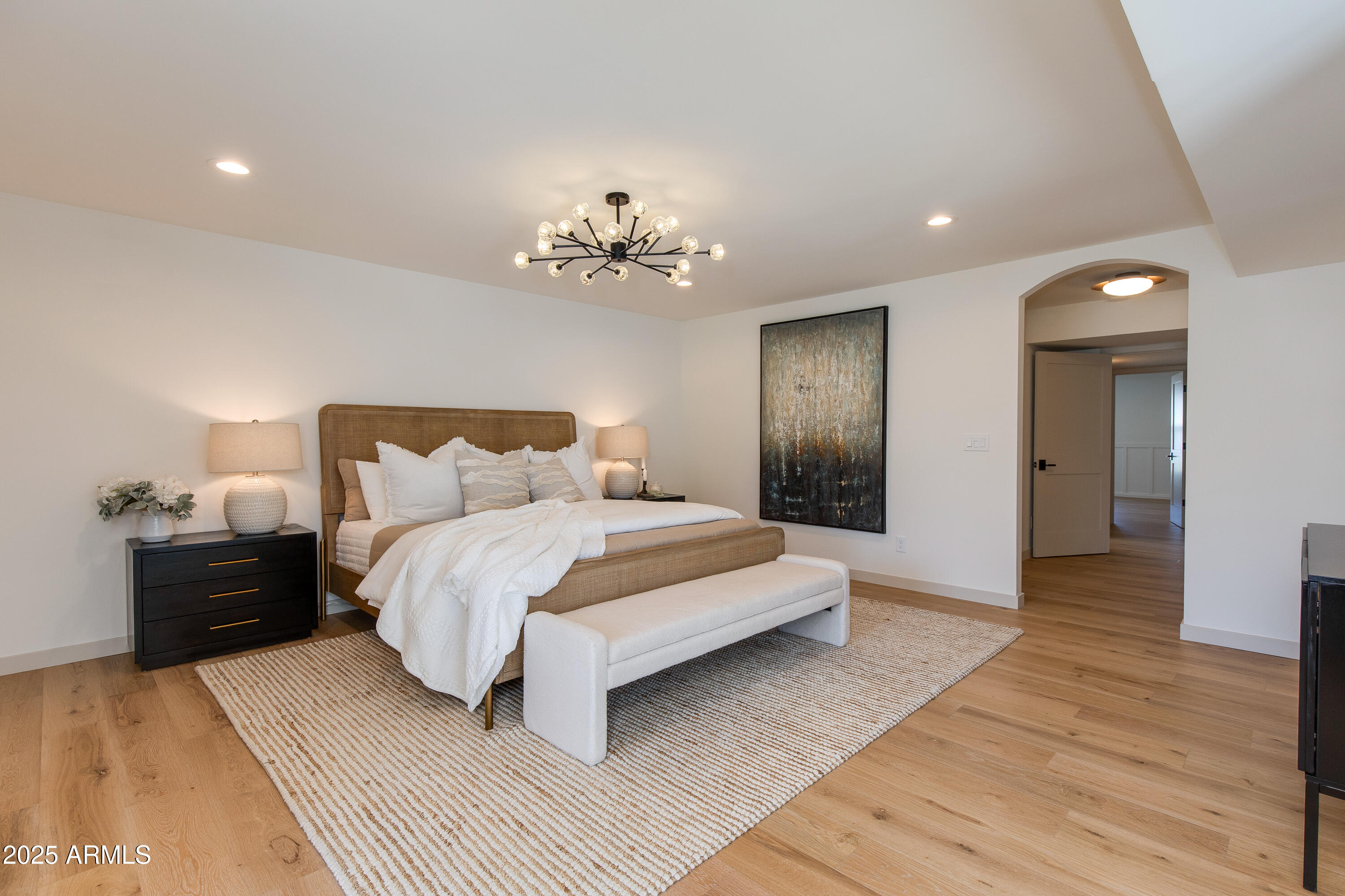 7328 East Laredo Lane Scottsdale, AZ 85250 - Photo 13 of 27 a spacious bedroom with a bed and a chandelier