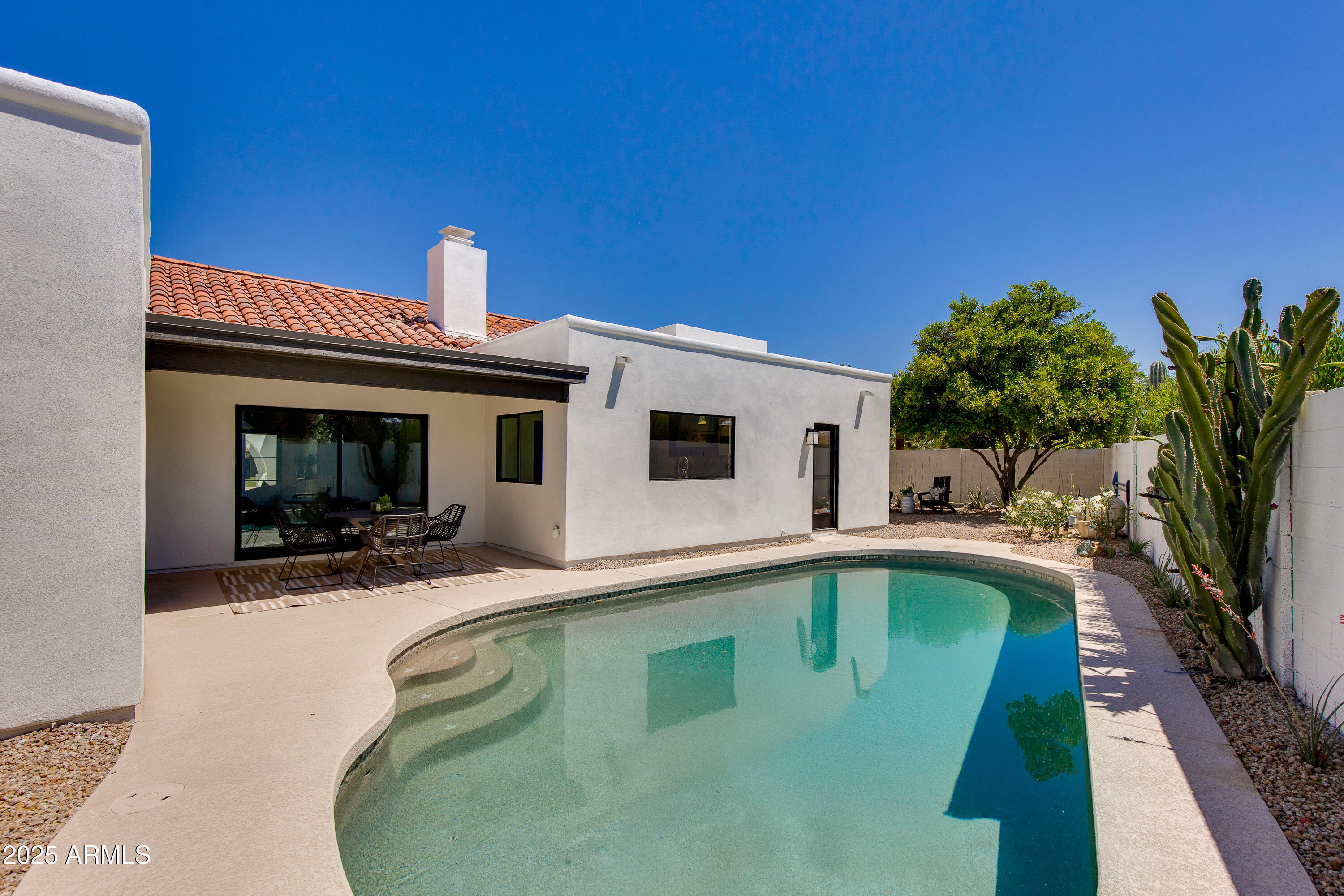 7328 East Laredo Lane Scottsdale, AZ 85250 - Photo 20 of 27 a swimming pool with outdoor seating