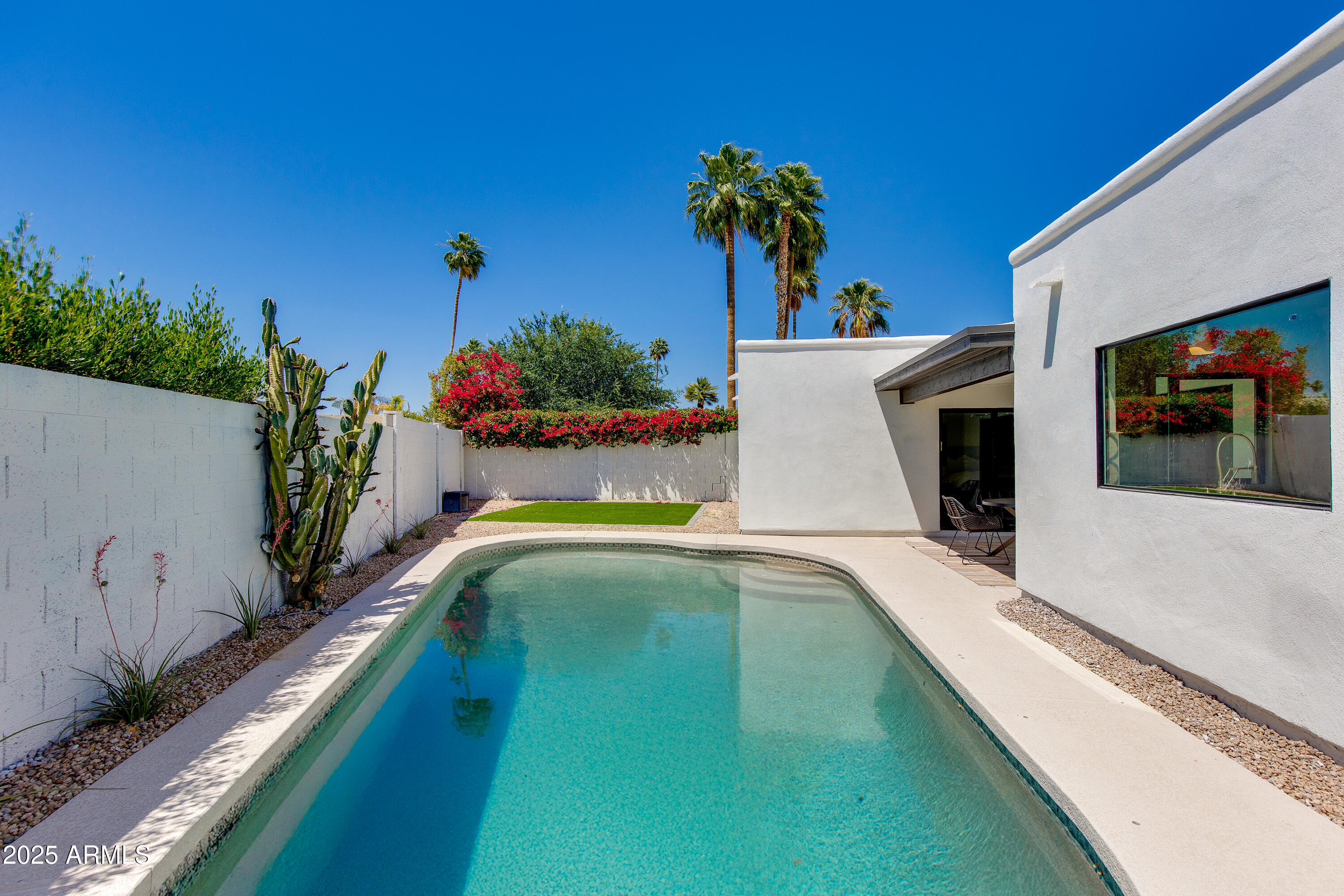 7328 East Laredo Lane Scottsdale, AZ 85250 - Photo 21 of 27 a view of a swimming pool with a yard