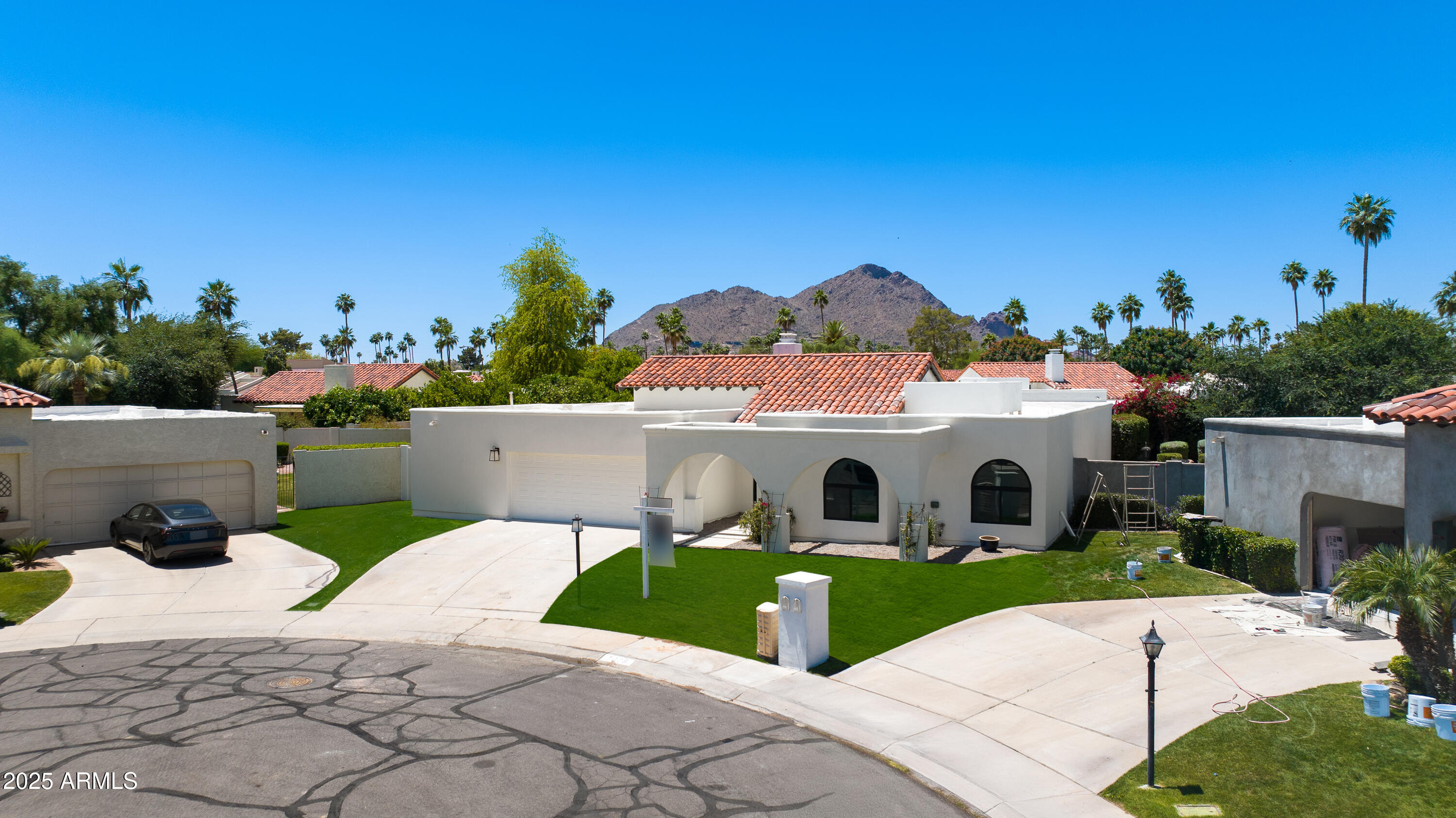 7328 East Laredo Lane Scottsdale, AZ 85250 - Photo 22 of 27 a view of a white house with a small yard and a large tree