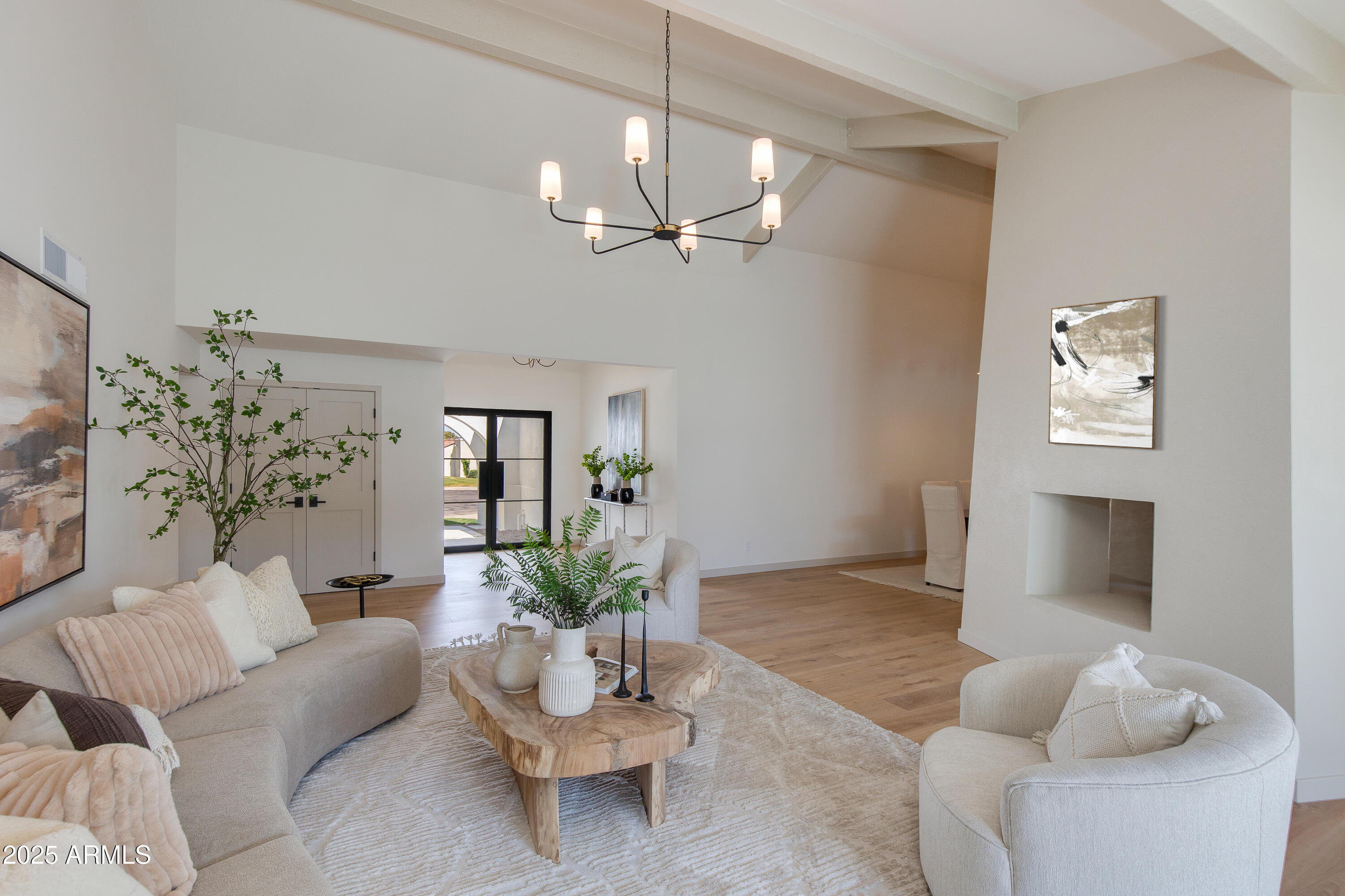 7328 East Laredo Lane Scottsdale, AZ 85250 - Photo 3 of 27 a living room with furniture a chandelier and a potted plant