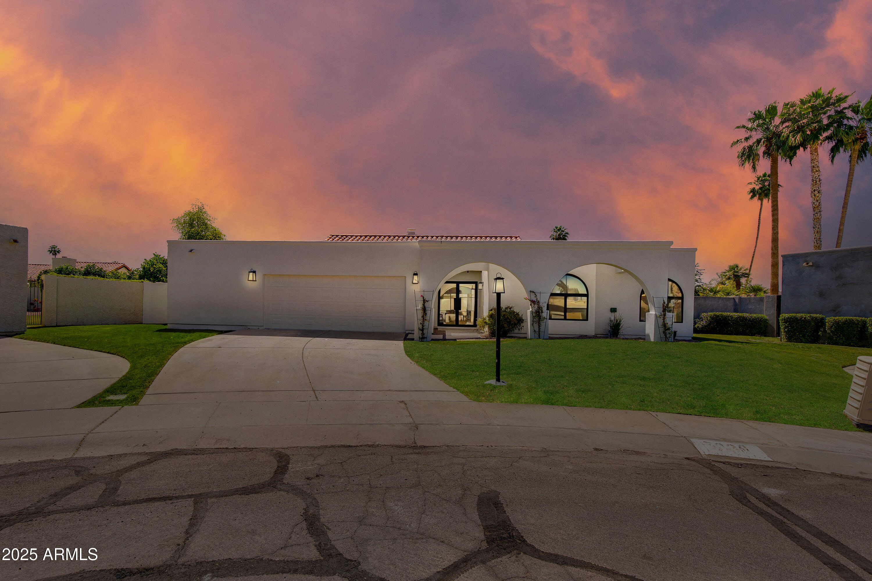 7328 East Laredo Lane Scottsdale, AZ 85250 - Photo 5 of 27 a front view of a house with a yard and garage