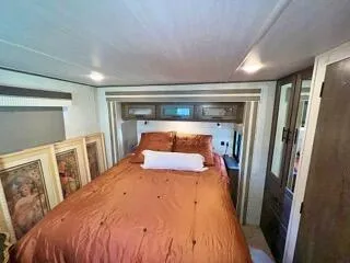 a bedroom with a bed and a mirror