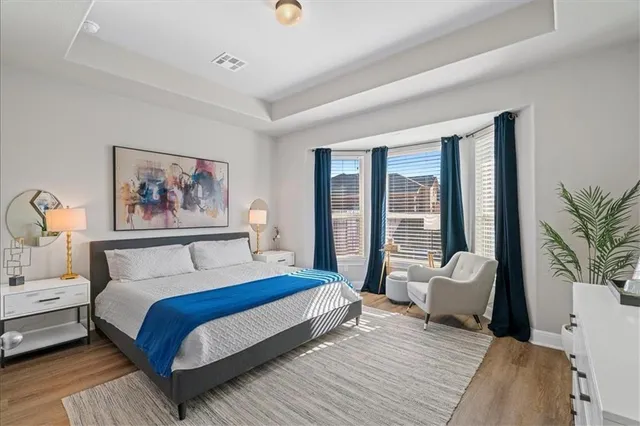 a bedroom with a large bed and a couch