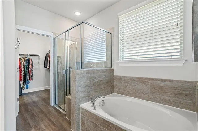 a bathroom with a bathtub and a shower