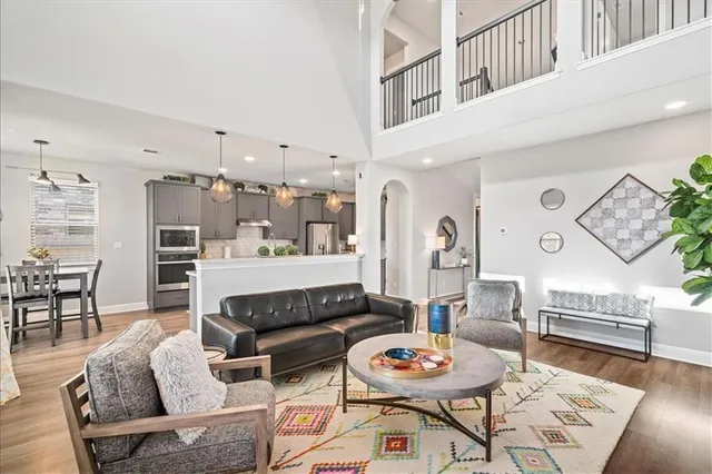 a living room with furniture and wooden floor