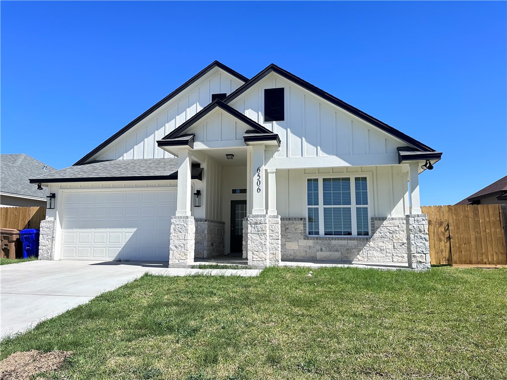 6506 Sam Houston Street Corpus Christi, TX 78414 - Photo 2 of 26 a front view of a house with a yard and garage