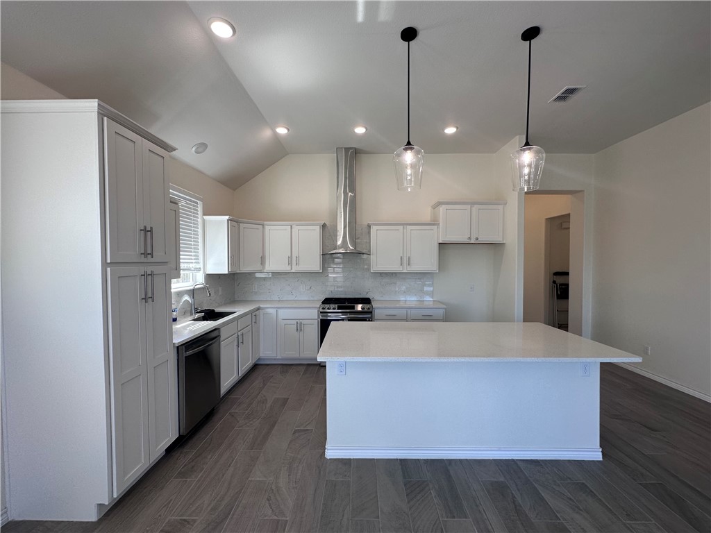6506 Sam Houston Street Corpus Christi, TX 78414 - Photo 5 of 26 a large kitchen with stainless steel appliances and wooden floors