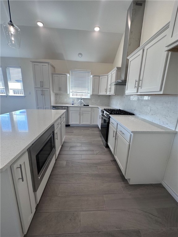 6506 Sam Houston Street Corpus Christi, TX 78414 - Photo 7 of 26 a large kitchen with stainless steel appliances granite countertop a large counter top a stove a sink and a refrigerator