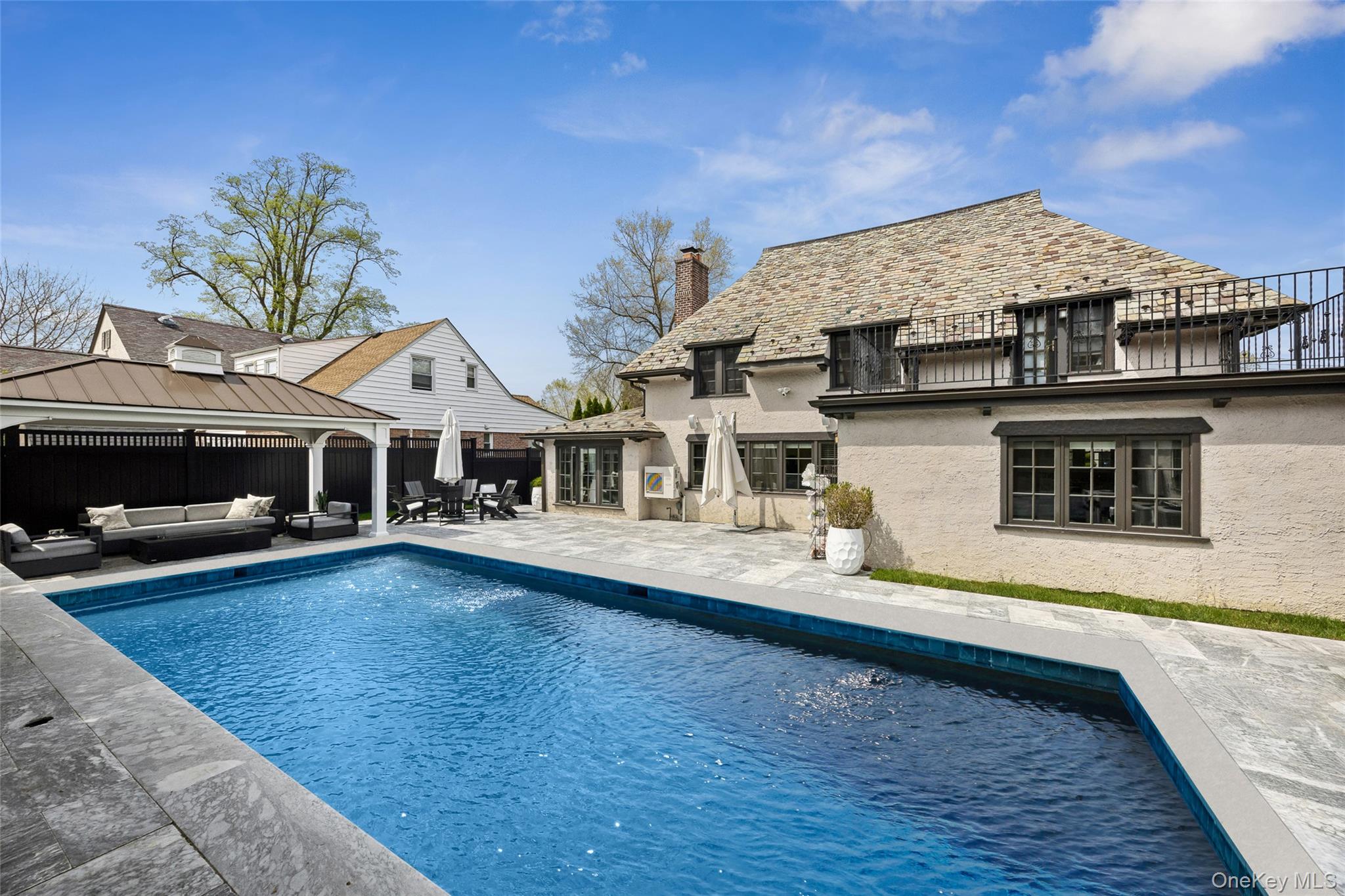 216 Beverly Road Queens, NY 11363 - Photo 25 of 50 a front view of a house with swimming pool
