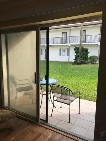 a view of an chairs and table in the balcony