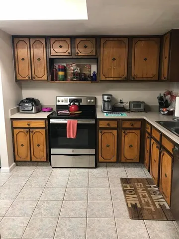 a kitchen with stainless steel appliances granite countertop a stove and cabinets