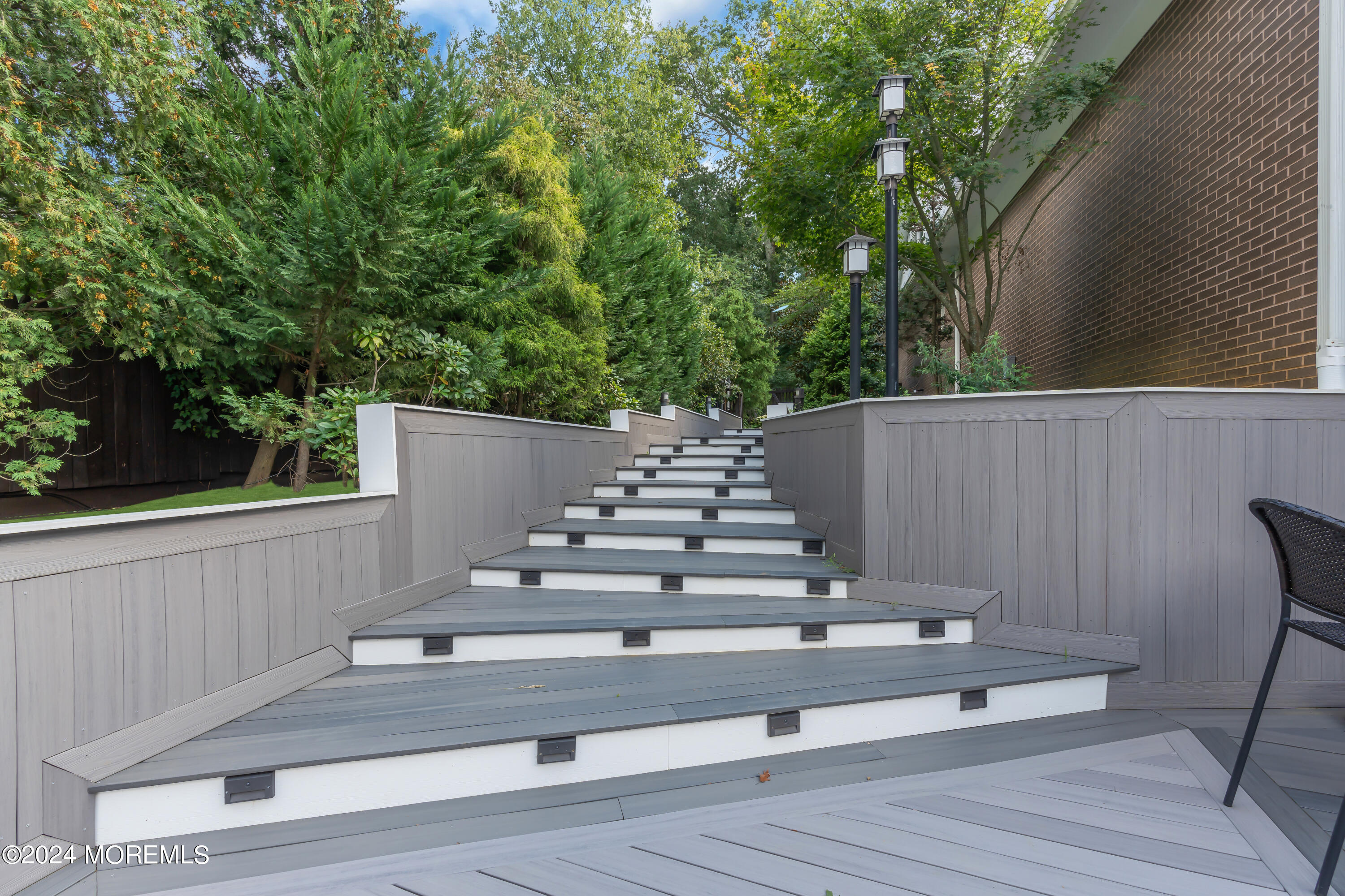 211 State Route 33 Freehold, NJ 07728 - Photo 35 of 64 a view of fountain in front of house with wooden floor and fence