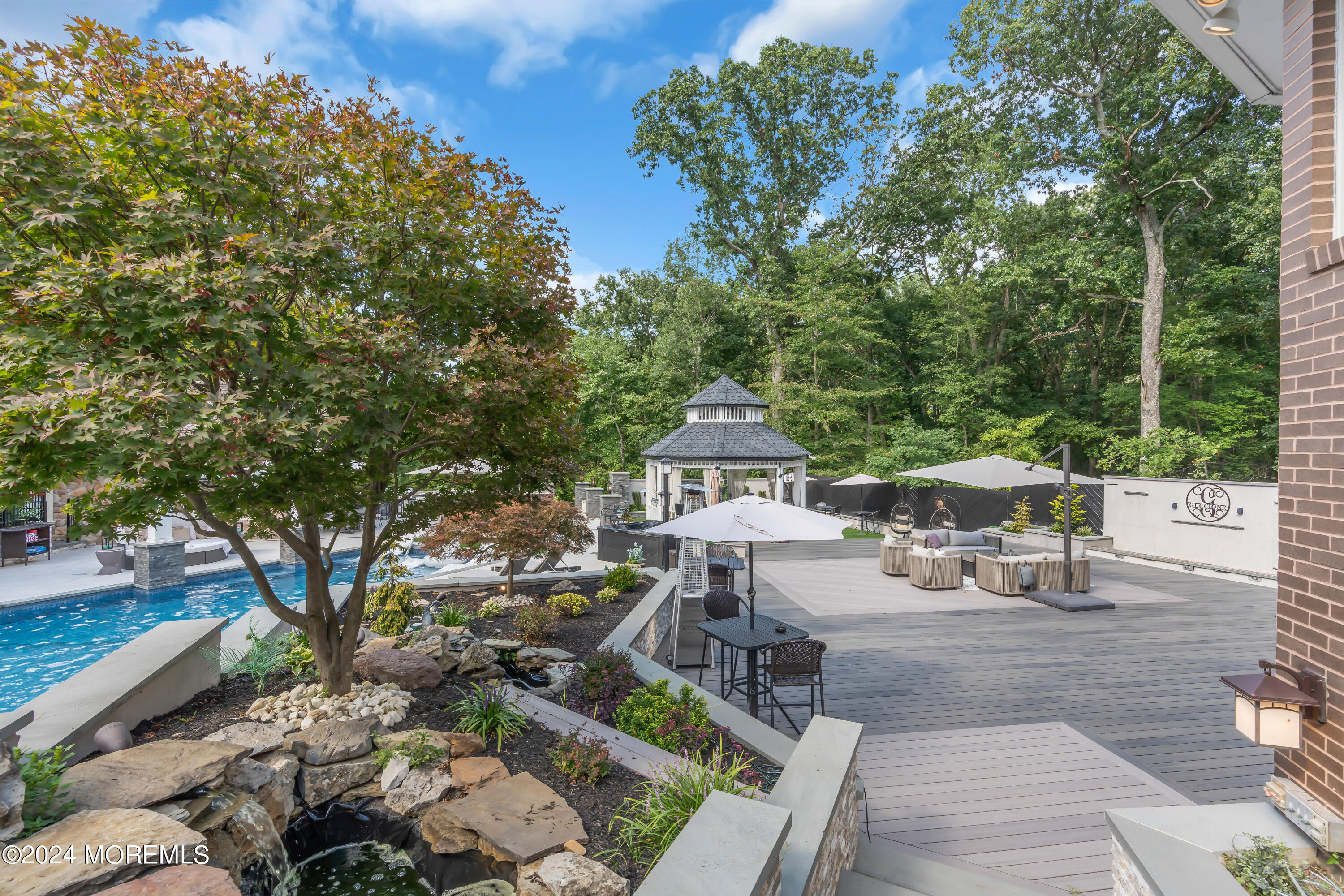 211 State Route 33 Freehold, NJ 07728 - Photo 37 of 64 a view of a patio with table and chairs and a large tree