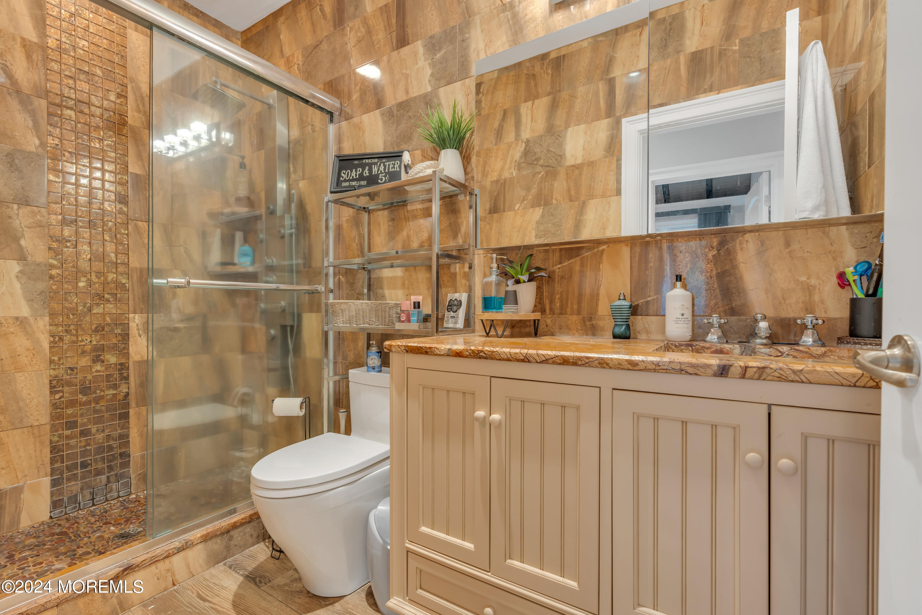 211 State Route 33 Freehold, NJ 07728 - Photo 55 of 64 a bathroom with a granite countertop sink a toilet and shower