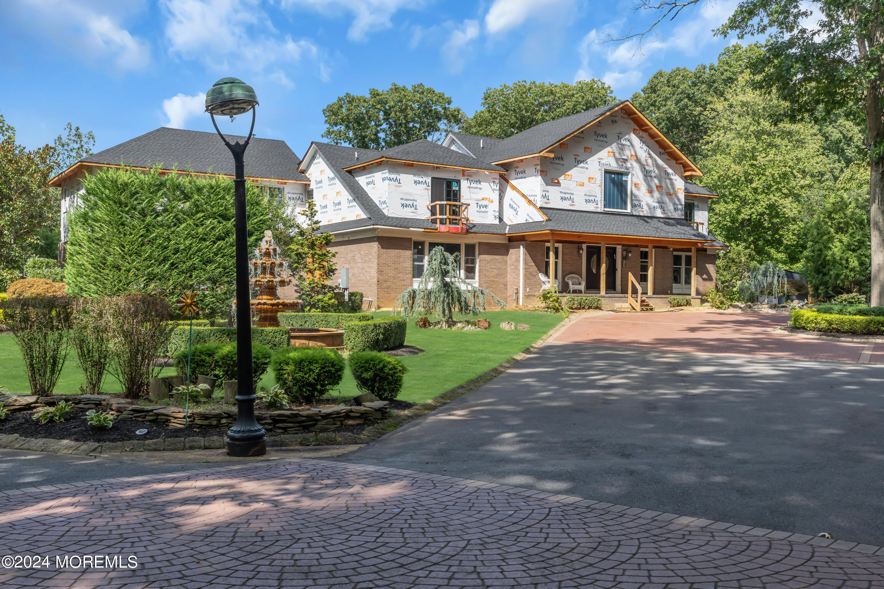 211 State Route 33 Freehold, NJ 07728 - Photo 6 of 64 a front view of a house with a yard and potted plants