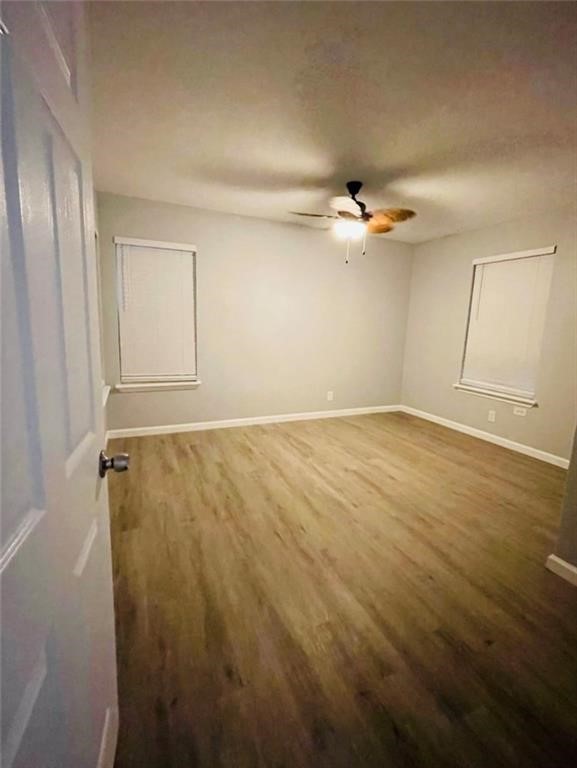 4309 Timon Boulevard Corpus Christi, TX 78402 - Photo 10 of 14 an empty room with a ceiling fan and wooden floor