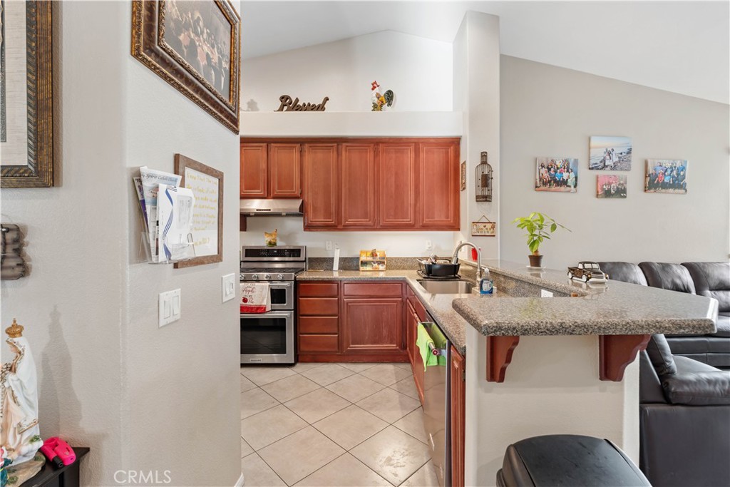 236 Jam Street Hemet, CA 92544 - Photo 13 of 36 a kitchen with stainless steel appliances granite countertop a refrigerator sink and stove
