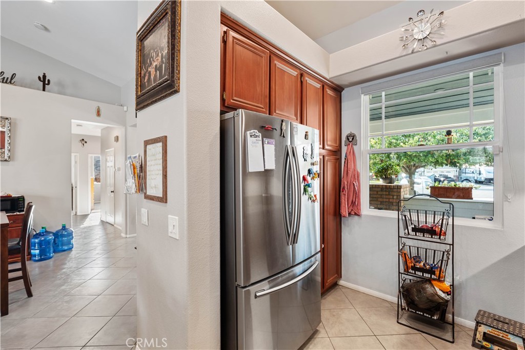 236 Jam Street Hemet, CA 92544 - Photo 15 of 36 a metallic refrigerator sitting in a kitchen next to a window