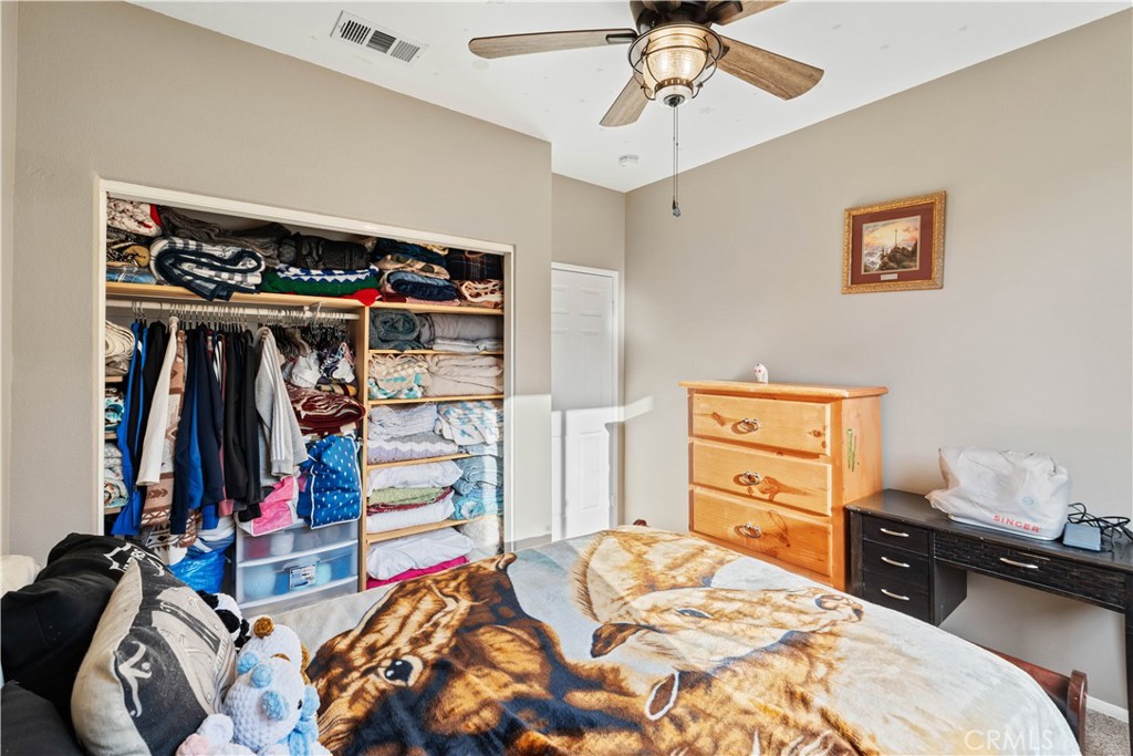 236 Jam Street Hemet, CA 92544 - Photo 22 of 36 a bed room with a bed and a walk in closet