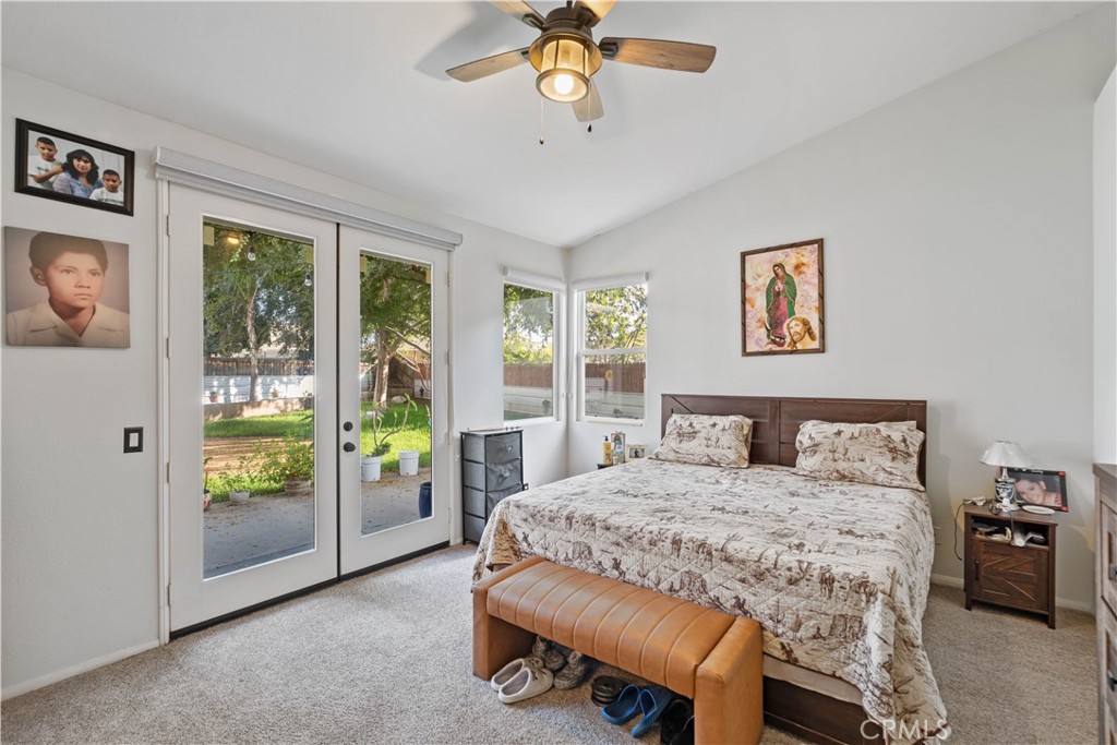 236 Jam Street Hemet, CA 92544 - Photo 25 of 36 a bedroom with a bed and a chandelier