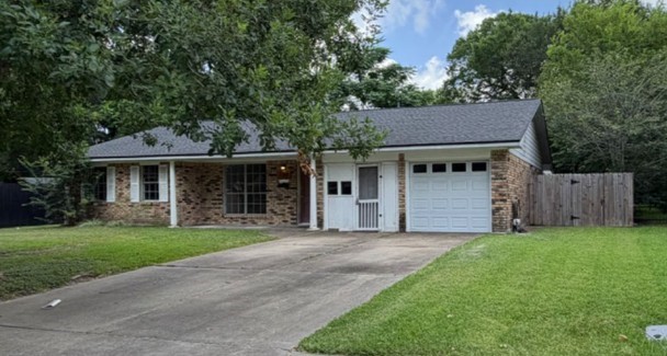 7314 Cannock Road Houston, TX 77074 - Photo 1 of 6 a front view of a house with a yard and garage