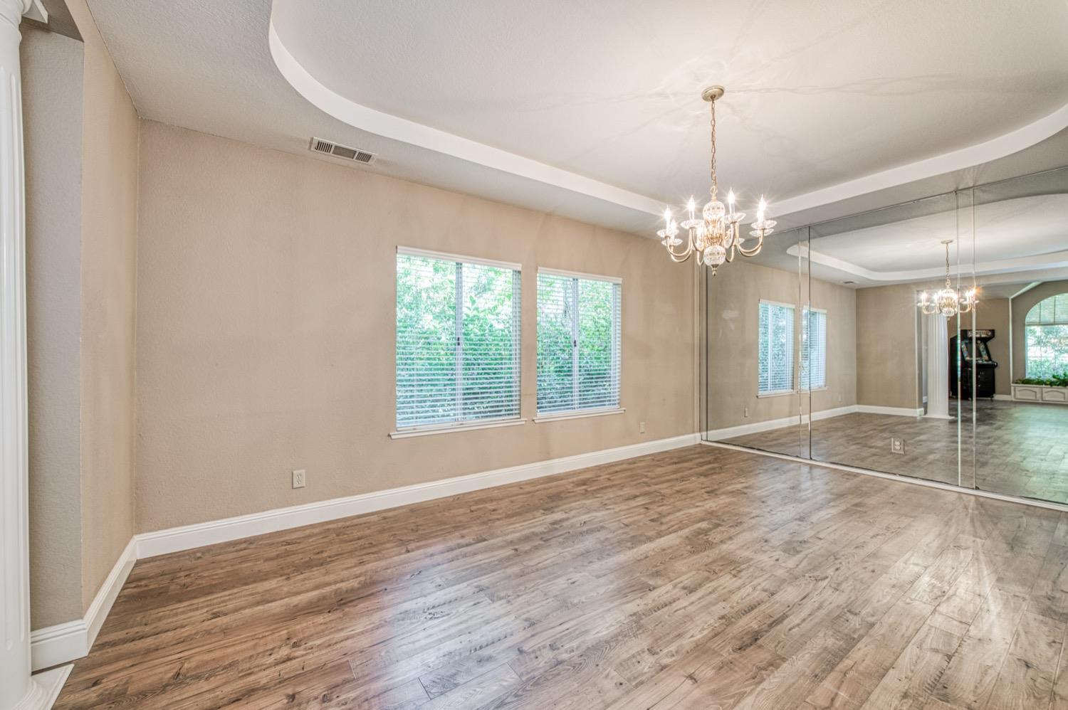 205 West Ridgepoint Drive Fresno, CA 93711 - Photo 12 of 49 a view of an empty room with wooden floor and a window