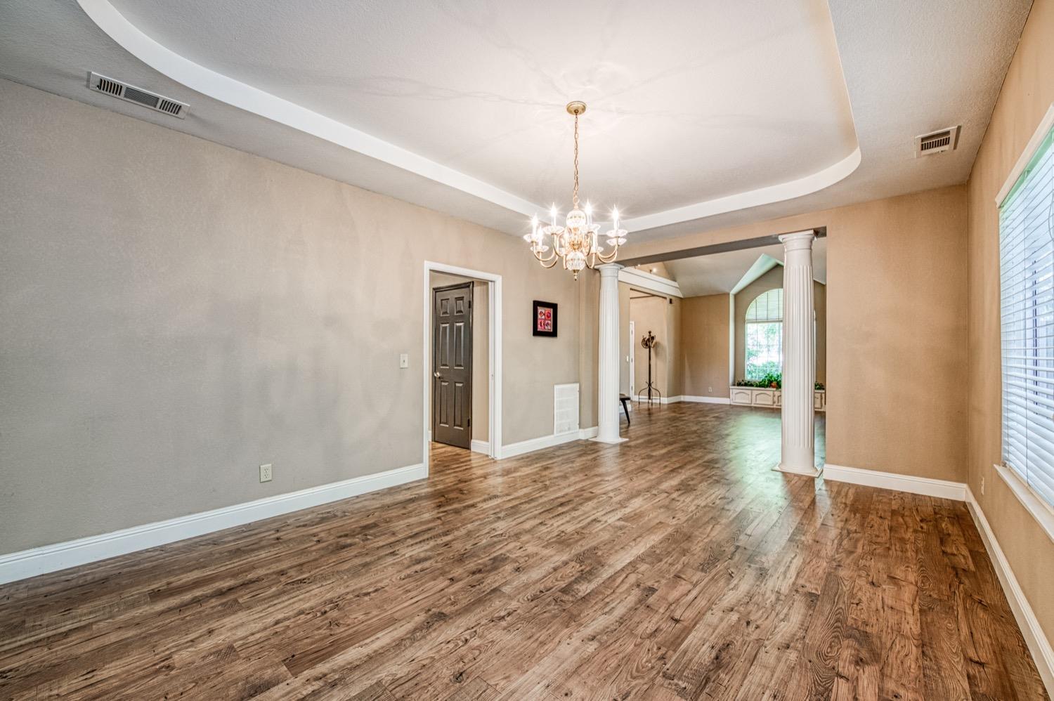 205 West Ridgepoint Drive Fresno, CA 93711 - Photo 13 of 49 a view of a hallway with wooden floor and chandelier