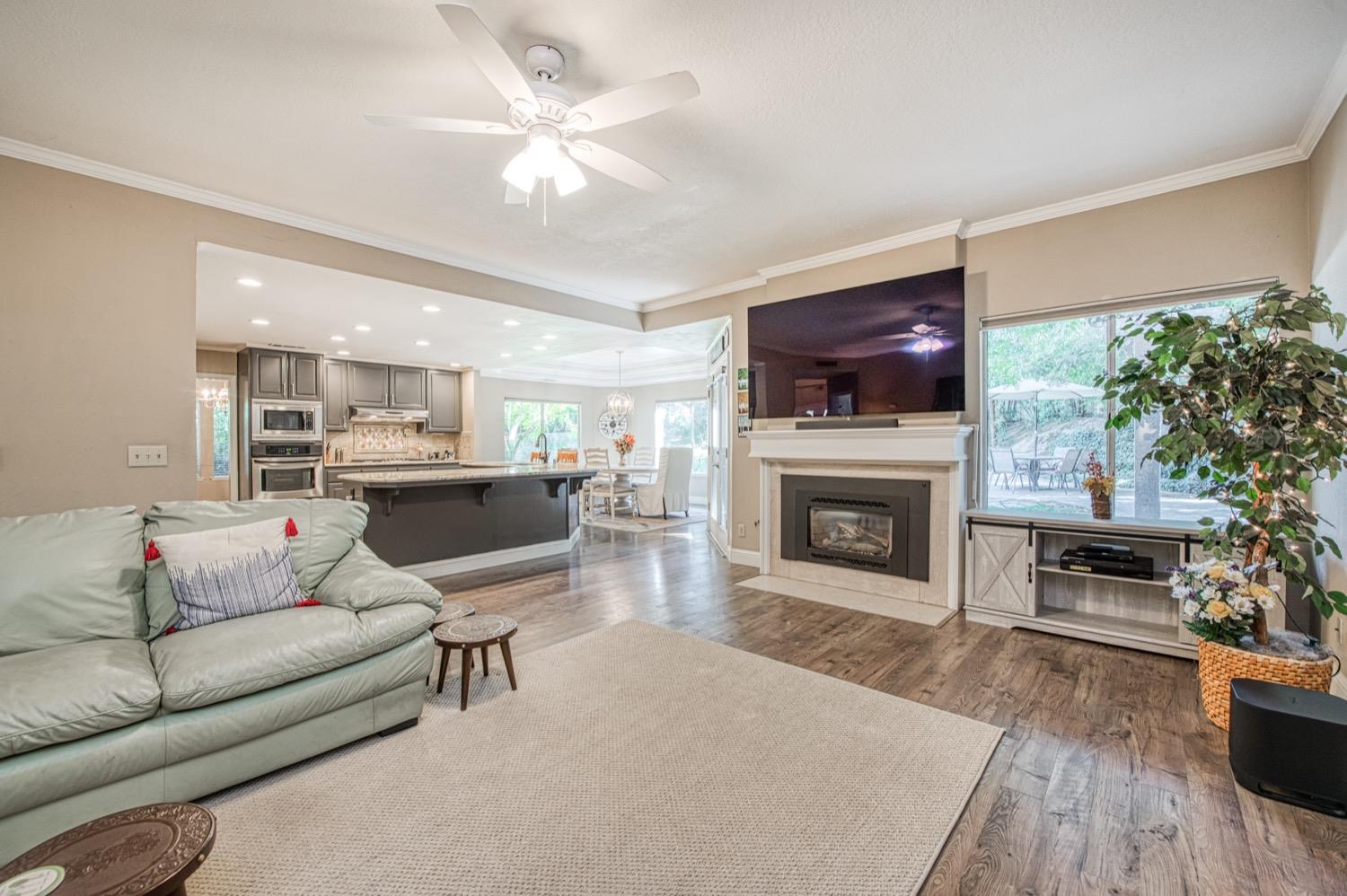 205 West Ridgepoint Drive Fresno, CA 93711 - Photo 17 of 49 a living room with furniture a fireplace and a flat screen tv