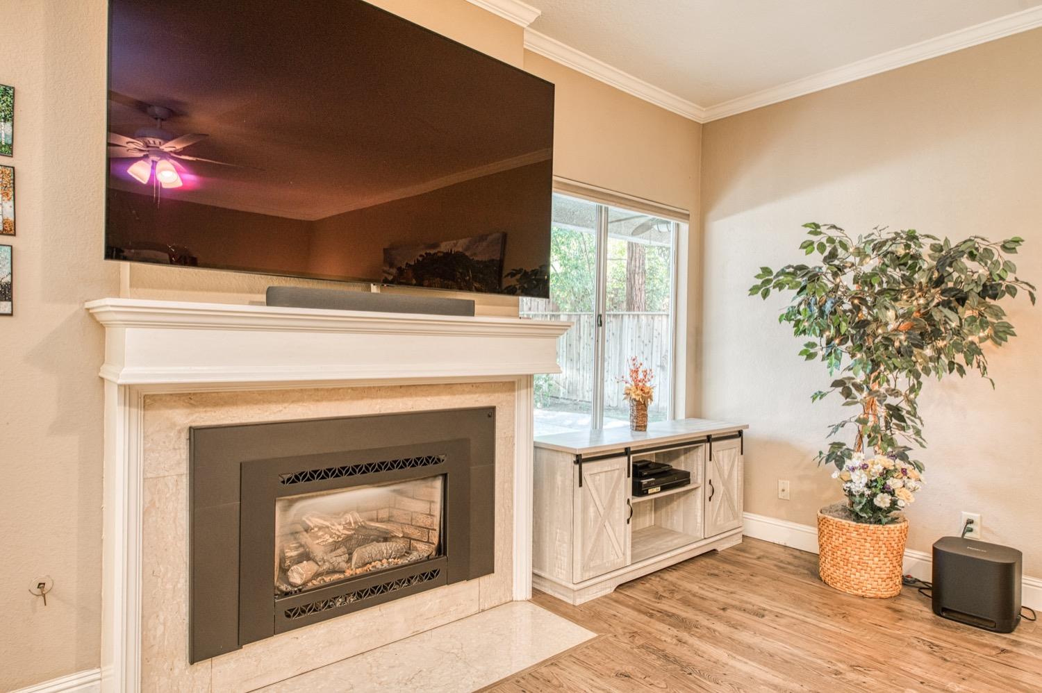 205 West Ridgepoint Drive Fresno, CA 93711 - Photo 18 of 49 a living room with a fireplace and a flat screen tv