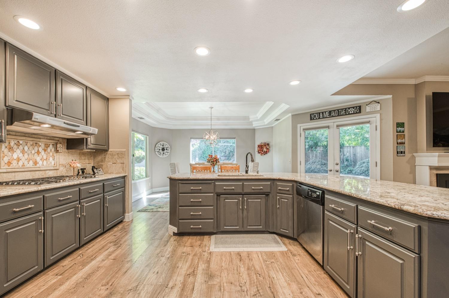 205 West Ridgepoint Drive Fresno, CA 93711 - Photo 20 of 49 a large kitchen with stainless steel appliances granite countertop a stove sink and cabinets