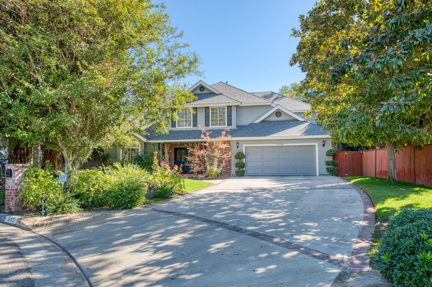 205 West Ridgepoint Drive Fresno, CA 93711 - Photo 2 of 49 a front view of a house with a yard and garage